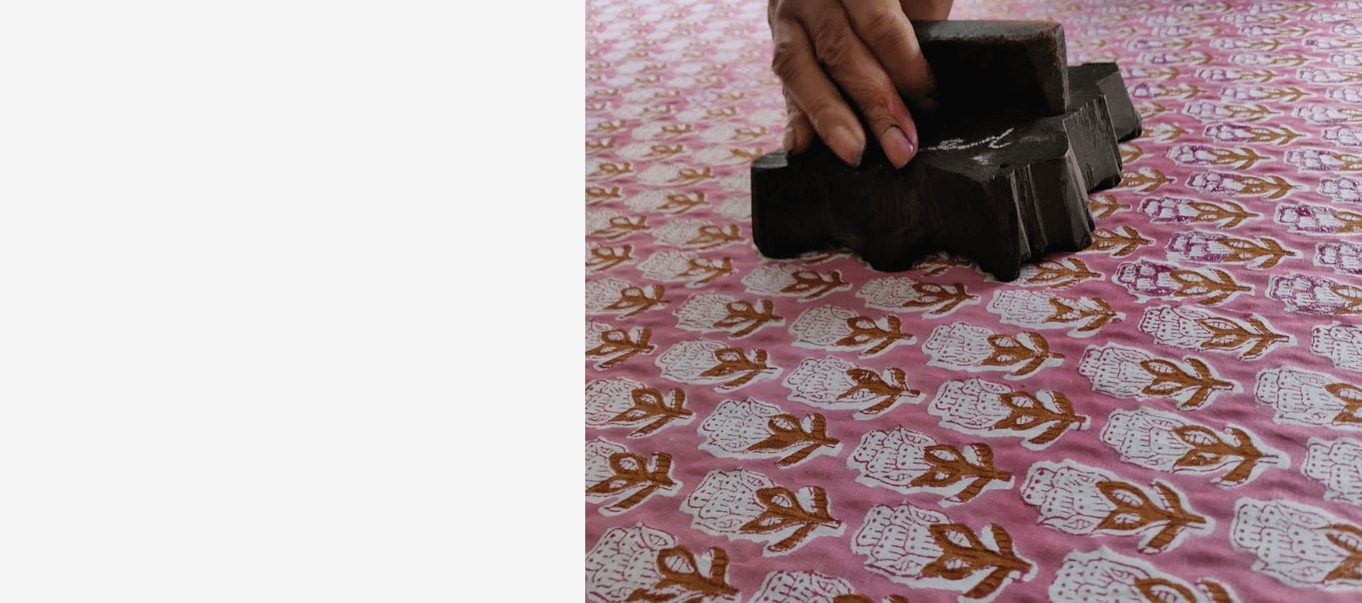 Artisan hand block printing cotton fabric in Jaipur